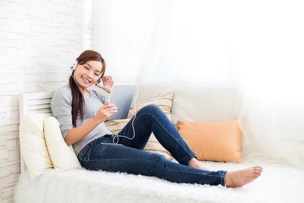 Woman enjoying listen to song on tablet pc