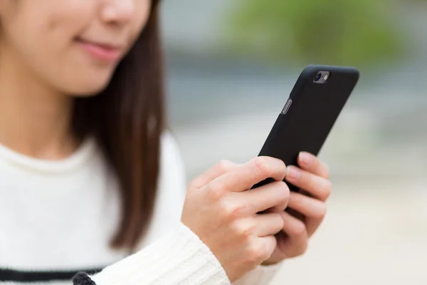 Woman sending text message on cellphone