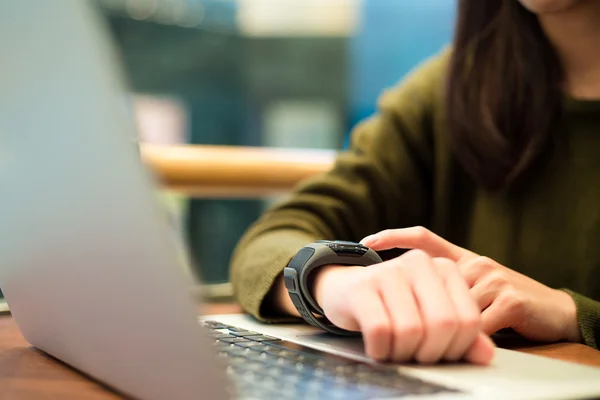 Woman touch on the screen of smart watch