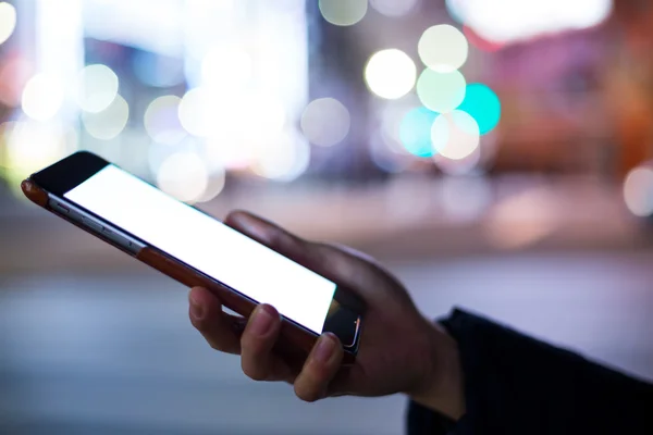 Woman using mobile phone at night