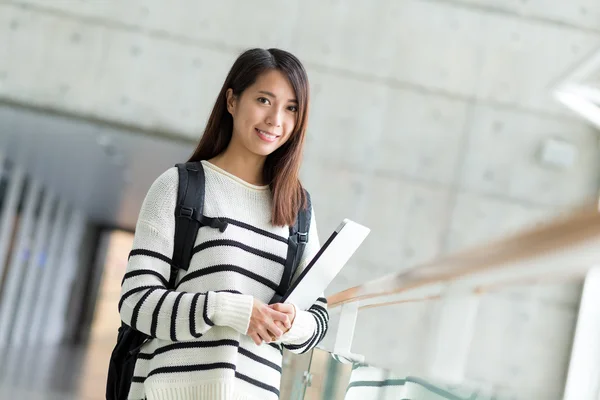 Asian female student with backpack and laptop