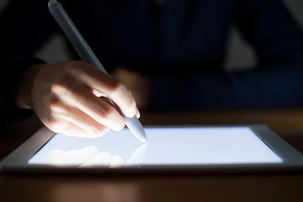 Woman writing something on tablet pc