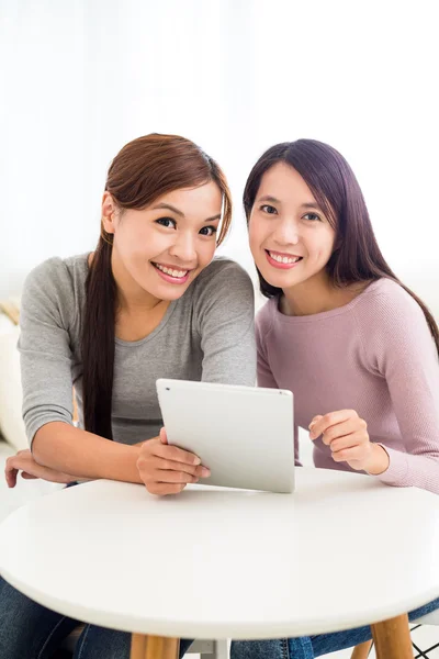 Women using tablet pc together