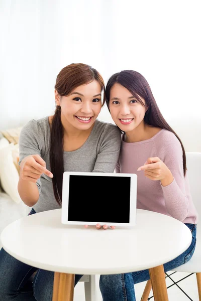 Women pointing to the blank screen of tablet pc