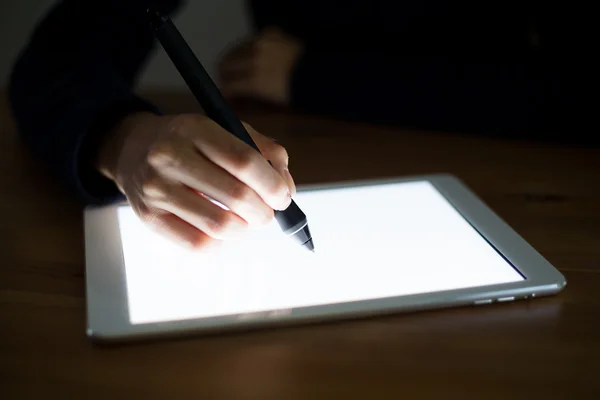 Woman writing something on tablet pc