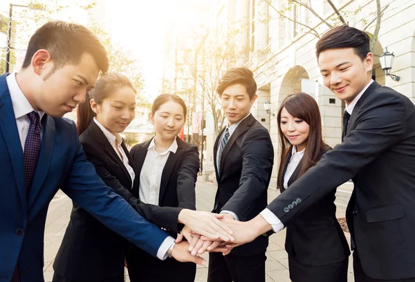 Business people joining hands together