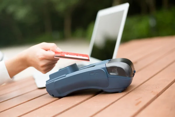 Woman using credit card to pay