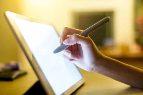 Woman drawing on tablet with pen