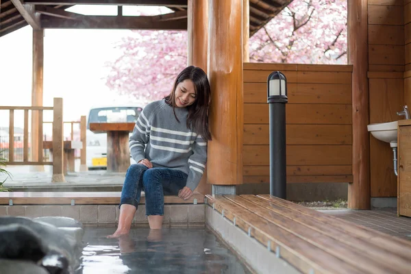 Woman enjoying hot spring on her feet