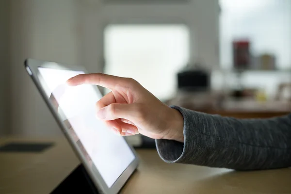 Hand presses on screen digital tablet