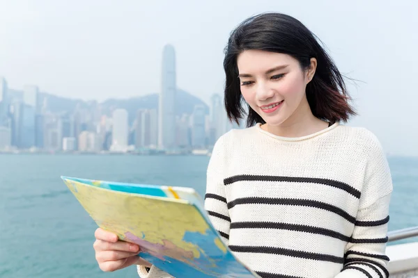 Woman seeking the location of the landmark in Hong Kong