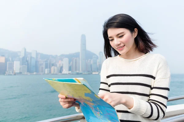 Woman travelling in Hong Kong and holding a map