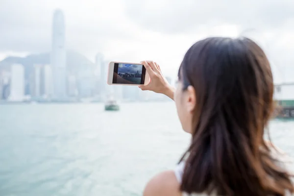 Woman taking photo of Hong Kong