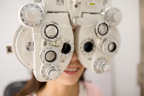 Woman doing eye test in optical clinic