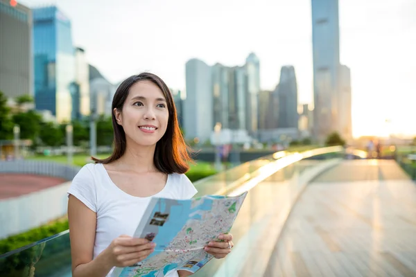 Woman using city map in Hong Kong