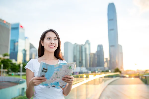 Woman using city map in Hong Kong