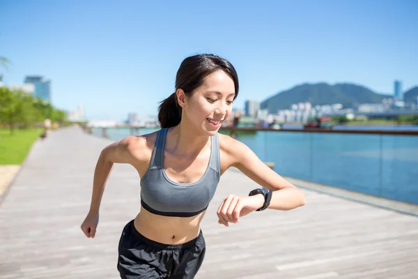 Woman using wearable watch during running