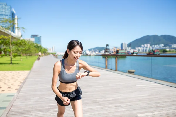 Woman using wearable watch during running