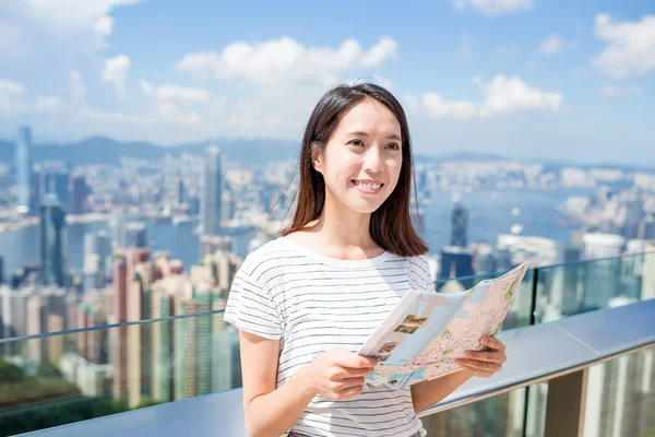 Woman holding city map in Hong Kong