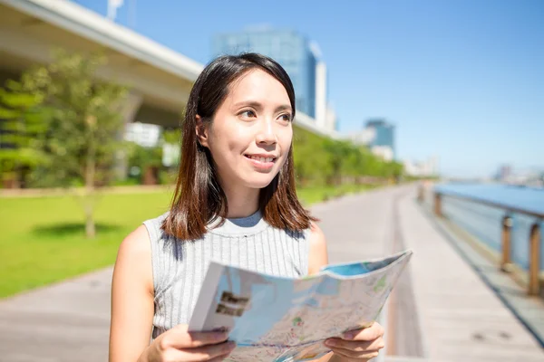 Woman using city map in Hong Kong