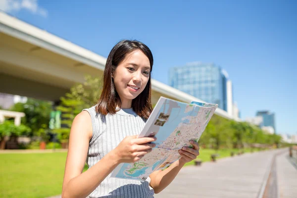 Woman looking at city map in Hong Kong