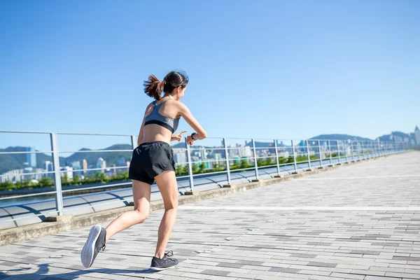 Woman running and using wearable watch