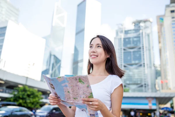Woman using city map in Hong Kong
