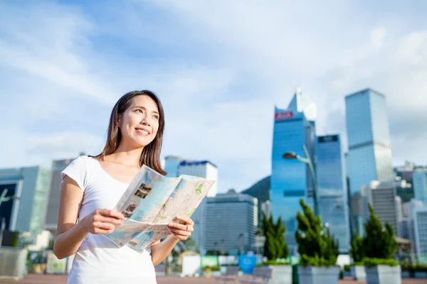 Woman using city map in Hong Kong