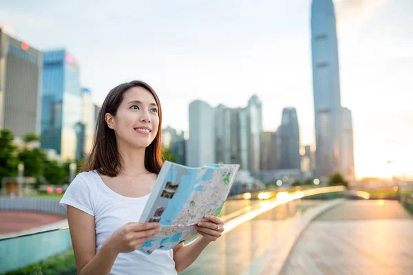 Woman using city map in Hong Kong