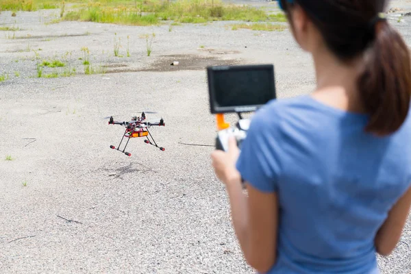 Woman controlling drone quadcopter