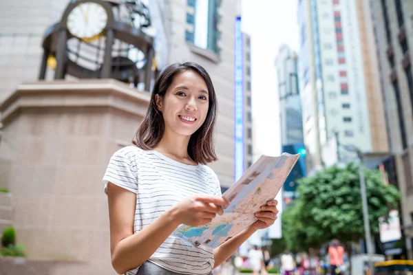 Woman using city map in Hong Kong