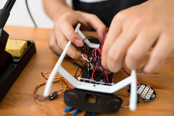 Man doing repair of drone