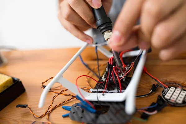 Man using welding to repair of drone