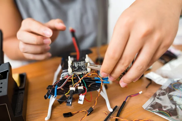 Man doing repair of drone