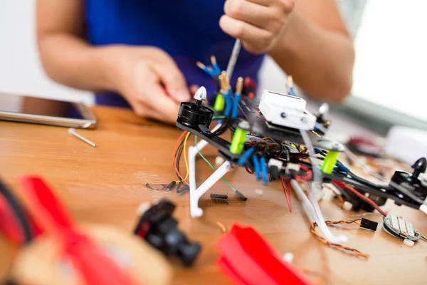 Man doing repair of drone