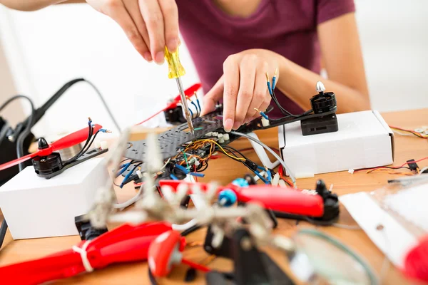 Woman doing repair of drone