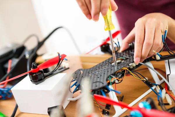 Woman doing repair of drone