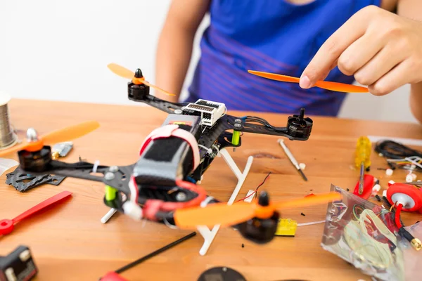 Man doing repair of drone