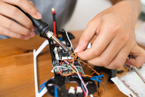 Man using welding to repair of drone