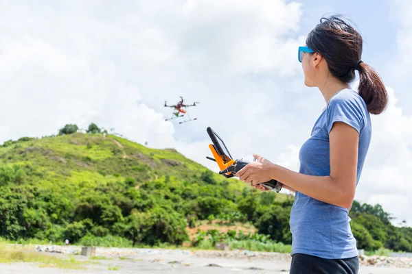 Woman controlling drone quadcopter