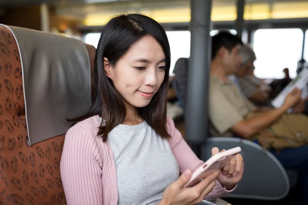 Woman using mobile phone on the ferry