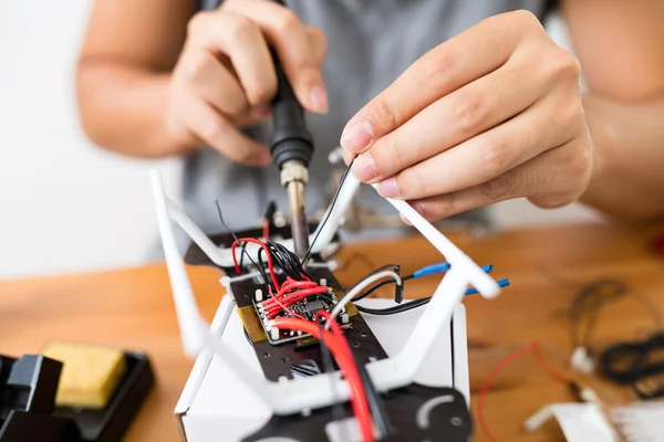 Man using welding to repair of drone