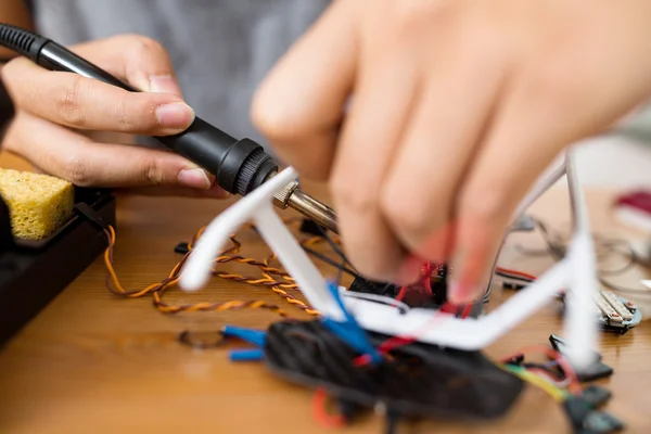 Man using welding to repair of drone