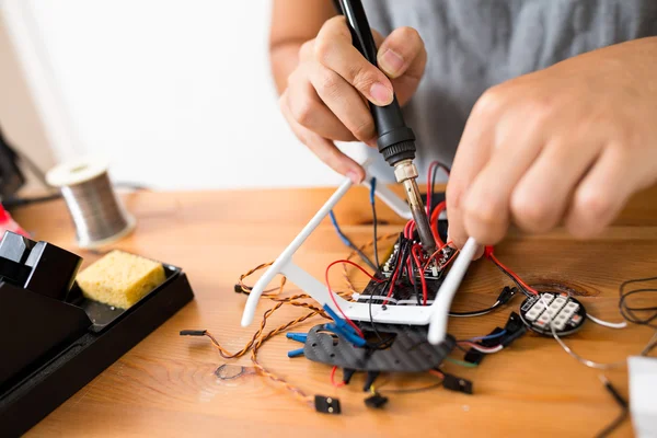 Man using welding to repair of drone