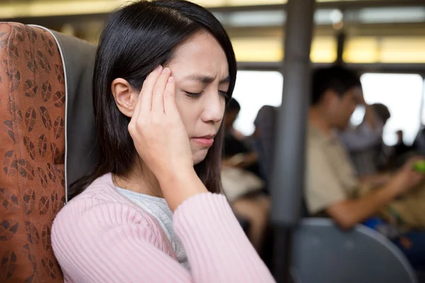 Woman suffering from headache on the ferry