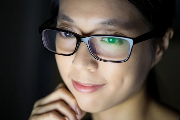 Woman in glasses at night