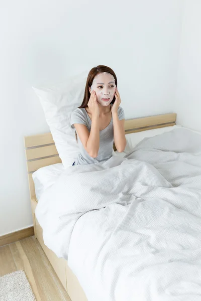 Asian woman adjusting paper mask