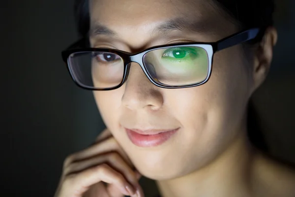 Asian woman looking at the screen