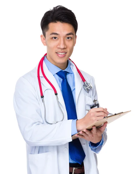 Young asian doctor take note on clipboard