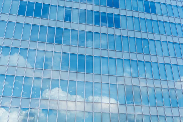 Blue clean glass wall of modern skyscraper